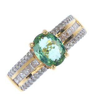 An 18ct gold tourmaline and diamond dress ring. The oval-shape green tourmaline, to the square-shape