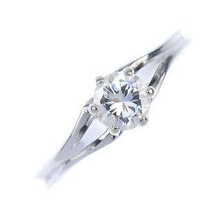 A diamond single-stone ring. The brilliant-cut diamond within a raised claw setting, to the tapered