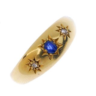 An Edwardian 18ct gold sapphire and diamond ring. The oval-shape sapphire and single-cut diamond sta