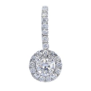 An 18ct gold diamond pendant. The brilliant-cut diamond, raised to the similarly-cut diamond surroun