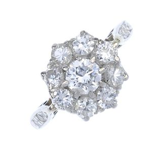 An 18ct gold diamond cluster ring. The brilliant-cut diamond cluster, to the single-cut diamond line