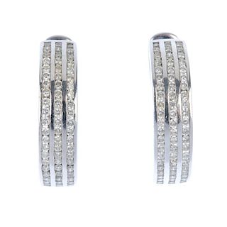 A pair of diamond earrings. Each designed as three brilliant-cut diamond lines, inset to the curved