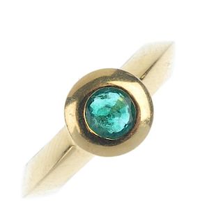 An emerald single-stone ring. The circular-shape emerald collet, to the angular band. Weight 9.2gms.