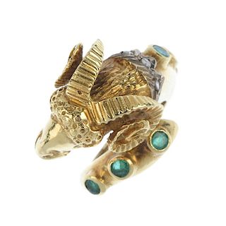 An emerald diamond and ruby dress ring. Designed as a textured rams head, with ruby eye detail and r