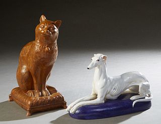 Two Italian Glazed Terracotta Figures, 20th c., of a greyhound on a blue cushion; and a seated brown cat on a cushion, Dog- H.- 9 3/4 in., W.- 15 1/4 