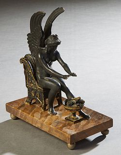 Patinated Spelter Seated Winged Female Angel Figure, 19th c., warming her hands over an open fire, on a faux bois wooden base on spelter ball feet, H.