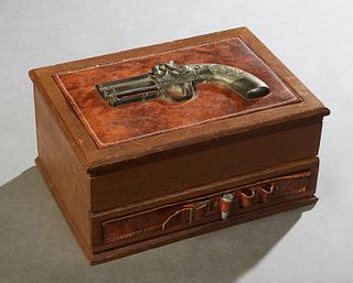 Carved Mahogany Gambler's Box, 20th c., the lid mounted with a relief pistol, opening to a fitted interior with a roulette wheel, dice, gambling chips