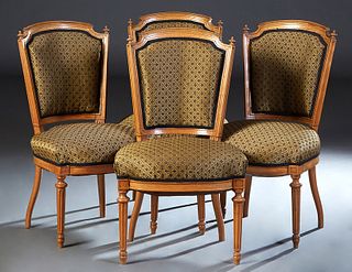 Set of Four Louis XVI Style Carved Cherry Dining Chairs, 20th c., the arched curved finialed upholstered back over a bowed cushioned seat, on turned t