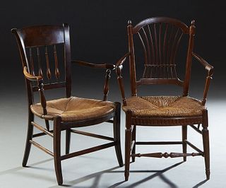 Two French Provincial Carved Walnut Rushseat Armchairs, early 20th c., one with a curved spindled back over a bowfront rush seat, flanked by curved ar