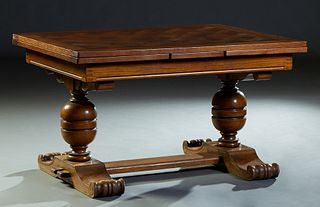 Spanish Renaissance Style Carved Oak Drawleaf Dining Table, 20th c., the parquetry inlaid top over two drawleaves and a wide skirt, on large urn form 