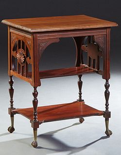American Carved Walnut Two Tier Side Table, c. 1900, the ogee edge top over pierced side supports, joined by a center bookshelf, on turned tapered sup
