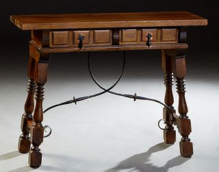 Spanish Renaissance Style Carved Walnut Console Table, 20th c., the rectangular top over two frieze drawers, on splayed turned legs joined by wrought 