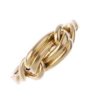 An early 20th century 18ct gold knot ring. Designed as a knot, with crossover shoulders and grooved