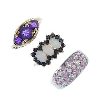 A selection of three gem-set dress rings. To include an amethyst three-stone ring, a 9ct gold oval o