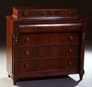 American Classical Carved Mahogany Chest, 19th c., the top with two glove drawers, over a setback convex frieze drawer above three deep drawers, flank