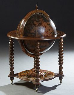 Beech World Globe Bar, 20th c., with antique map decoration, the interior with a fitted revolving tray, on rope twist legs to a shaped lower shelf, wi