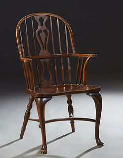 English Carved Chestnut Windsor Armchair, early 20th c., the arched spindled back with a pierced center splat, to curved scrolled flat arms, above a s