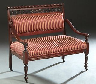 American Carved Mahogany Hall Bench, late 19th c., the twist carved spindled crest rail over an upholstered back, flanked by curved arms and a cushion