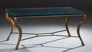 Contemporary Gilded Steel and Beveled Glass Coffee Table, 20th c., the beveled thick glass top on square cabriole legs with block feet, joined by a st