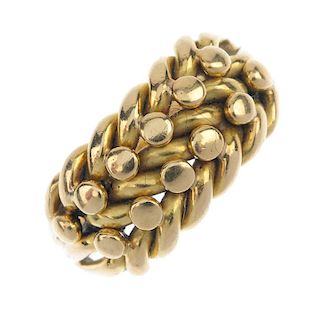 A mid 20th century 18ct gold keepers ring. The bead accents, to the interwoven lines. Weight 10.2gms