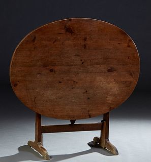 French Provincial Carved Pine Wine Tasting Table, 19th c., the oval top on a trestle base, with a fold out V-shaped support, H.- Closed 1/2 in., W.- 4