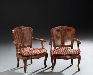 Pair of Louis XV Style Carved Beech Children's Fauteuils, 20th c., with an arched caned back and bowed seat, flanked by curved arms, on scrolled cabri
