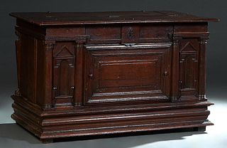 French Louis XIII Style Carved Oak Coffer, 18th c., the stepped folding top over a central fielded panel cupboard door flanked by engaged columns, and