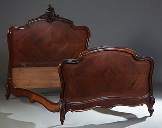 French Louis XV Style Carved Rosewood Double Bed, early 20th c., the arched crotched headboard with a C-scroll and leaf crest, to shaped wood rails an