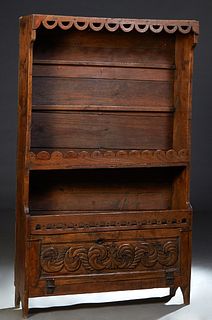 French Provincial Carved Oak Vaisselier, 19th c., the pierced arched crown over two rear plate racks and an arched top shelf over a fall front cupboar