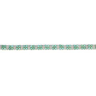 A 14ct gold emerald and diamond bracelet. Designed as a series of circular-shape emerald quatrefoils