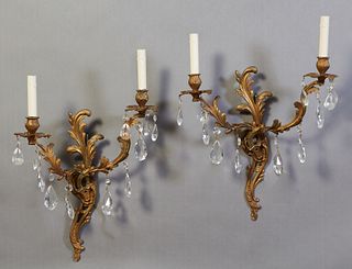 Pair of Louis XV Style Two-Light Bronze Wall Sconces, 20th c., scroll and leaf form back plate issuing two curved leaf form arms, hung with prisms, El