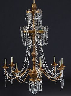 French Style Eight Light Gilt Iron and Wood Chandelier, 20th c., the carved relief support with two upper graduated gilt iron rings hung with prisms a