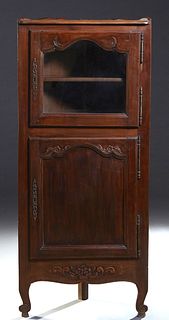 French Provincial Louis XV Style Carved Beech Corner Cabinet, early 20th c., the stepped crown over an arched glazed panel door with iron fiche hinges