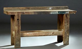 French Carved Beech Cabinetmaker's Work Bench, late 19th c., the two board 2 1/2 in. thick top above a front rail with a removable wood vise, on large