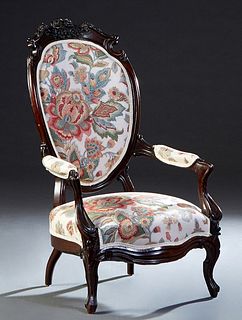 American Rococo Style Carved Mahogany Fauteuil, 19th c., the canted floral carved upholstered back to upholstered arms and a bowed cushion seat, on re