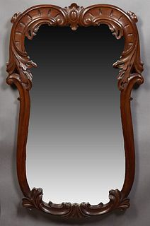 American Carved Walnut Dresser Mirror, 19th c., with a wide leaf and scroll carved frame around a shaped mirror plate, H.- 42 3/4 in., W.- 27 1/2 in.,