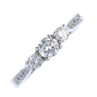 A platinum diamond three-stone ring, The graduated brilliant-cut diamond line, with similarly-set di