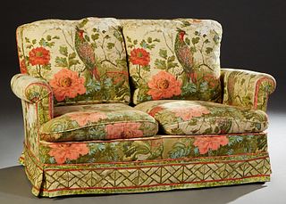 French Art Deco Settee, c. 1940, the curved back with two cushions over rolled arms, to two removable rounded seat cushions, on block feet, with brigh