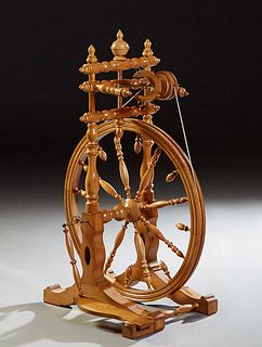 French Provincial Carved and Turned Beech Treadle Spinning Wheel, 19th c., with a pedal mechanism, H.- 40 in., W.- 16 1/2 in., D.- 27 in.