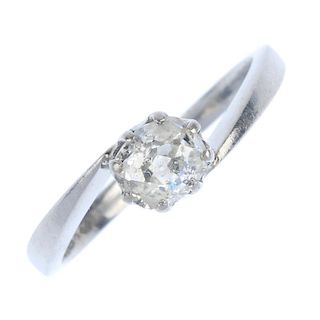 A platinum diamond single-stone ring. The old-cut diamond, to the asymmetric shoulders and plain ban