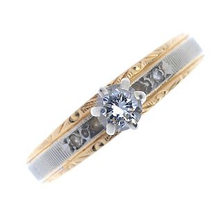 A diamond single-stone ring. The brilliant-cut diamond, raised to the bi-colour and vari-texture ban