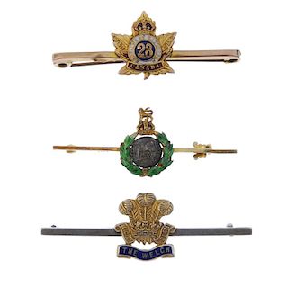 A selection of five military brooches. To include an enamel Royal marines bar brooch, a Royal welsh