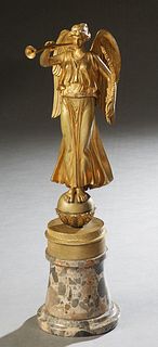 Continental School, "Trumpeting Angel," 19th c., gilt bronze mounted on a cylindrical stepped gray breche d'Alpes base, H.- 18 1/2 in., W.- 4 1/2 in.,