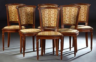 Set of Six French Carved Oak Louis XVI Style Dining Chairs, 20th c. the canted curved floral carved crest rail over an upholstered back to a shield sh