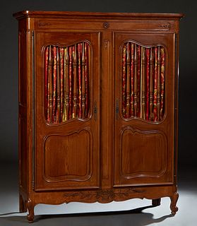 French Provincial Louis XV Style Carved Oak Armoire, 20th c., the stepped ogee edge crown over double doors with spindled upper panels over fielded lo