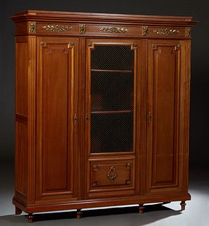 French Louis XVI Style Carved Mahogany Bookcase, early 20th c., the stepped crown over an ormolu mounted frieze above a center door with a brass mesh 