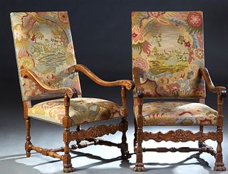 Pair of French Renaissance Style Carved Walnut Fauteuils, late 19th c., the canted arched back over scrolled curved arms, to a cushioned seat on paw f