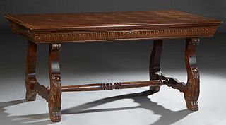 Spanish Renaissance Style Carved Oak Dining Table, the parquetry top over a wide skirt, on large trestle supports with paw feet, joined by a turned ta