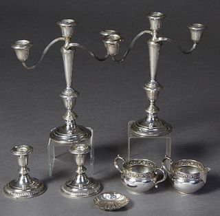 Group of Seven Sterling Silver Items, 20th c., consisting of a pair of weighted low candlesticks by Frank Whiting; a pair of weighted three light cand
