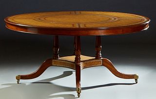 Georgian Style Carved Mahogany Circular Tooled Leather Top Dining or Center Table, 20th c., possibly by Maitland Smith, the finely tooled leather top 